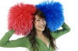Young cheerleader with red and blue pom-poms smiling