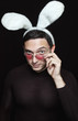 playboy with bunny ears and heart shaped sunglasses on black
