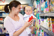 Photo: Mother Shopping with Baby in Supermarket Mother Shopping with Baby in Supermarket