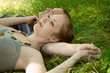 The man and the woman lie in a grass