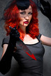 Foto: Portrait of a female vampire with bloody knife in hand Portrait of a female vampire with bloody knife in hand