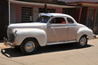 Photo: Vintage white car on the road Vintage white car on the road