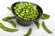 Edamame soy beans in a brown ceramic dish
