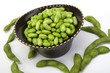 Edamame soy beans in a brown ceramic dish