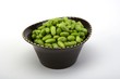 Edamame soy beans in a brown ceramic dish