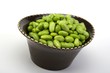 Edamame soy beans in a brown ceramic dish
