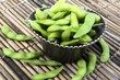 Edamame soy beans in a brown ceramic dish