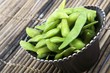 Edamame soy beans in a brown ceramic dish