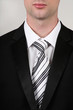 Foto: Portrait of businessman wearing a black suit and black white tie Portrait of businessman wearing a black suit and black white tie