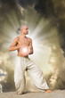 Man Practises Tai holding a Ball of Energy with Dramatic Cloudy