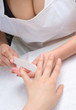 Applying manicure with nail file