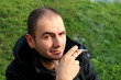 Caucasian man holding a cigar