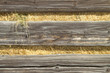 Hay peeks through a barn wall