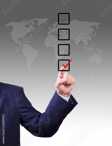 Photo: business man hand choose check mark on box business man hand choose check mark on box