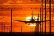 Jet plane landing or departing in airport at sunset