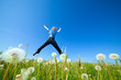 Young man jumping on the spring field Young man jumping on the spring field