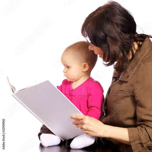 Photo: Infant baby girl discovering books with grandma Infant baby girl discovering books with grandma