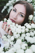 Beautiful young woman near blossom bush Beautiful young woman near blossom bush