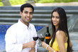 Photo: Young romantic couple celebrating with wine. Young romantic couple celebrating with wine.