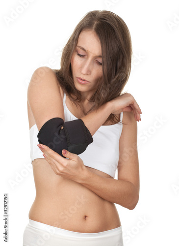 Photo: young woman in medical bandage, elbow support young woman in medical bandage, elbow support
