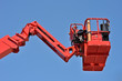 red hydraulic construction cradle against the blue sky