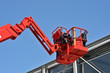 red hydraulic construction cradle against the blue sky