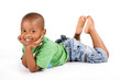 Adorable black boy laying on the floor smiling Adorable black boy laying on the floor smiling