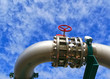 Industrial zone, Steel pipelines and valves against blue sky