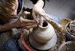 hands of a potter, creating an earthen jar on the circle hands of a potter, creating an earthen jar on the circle