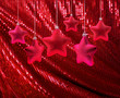 Red stars on red glitter canvas
