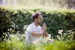 A young man meditating outdoors