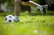 A young man kicking a football outdoors