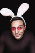 young man with white bunny ears and heart shaped glasses