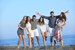 happy young  people group have fun on beach