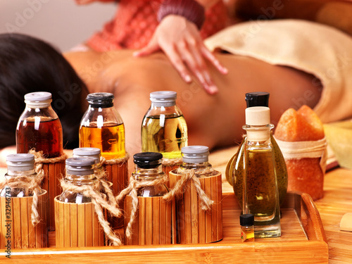 Photo: Woman getting massage in bamboo spa. Woman getting massage in bamboo spa.