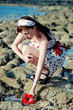 pretty young woman staying on the beach with hibiscus