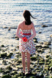 pretty young woman staying on the beach with hibiscus
