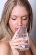 Beautiful fashion model drinking water