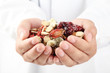 Doctor holding handful of Chinese traditional herbal medicine.
