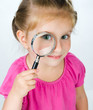 little girl looking through a magnifying glass little girl looking through a magnifying glass