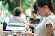 Attractive woman reading book/magazine and drinking drink