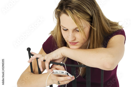 Photo: Woman with Digital Audio Device with Clipping Path Woman with Digital Audio Device with Clipping Path