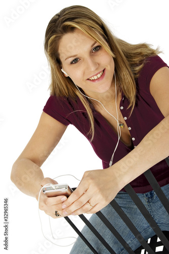 Photo: Attractive Woman with Digital Audio Device with Clipping Path Attractive Woman with Digital Audio Device with Clipping Path