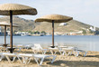 beach with umbrellas lounge chairs Ios Island Cyclades Greece beach with umbrellas lounge chairs Ios Island Cyclades Greece