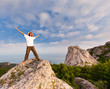 Photo: hiker at the top of a rock with his hands up enjoy sunny day hiker at the top of a rock with his hands up enjoy sunny day