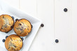 three muffin on a white square plate, white table