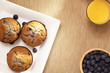 muffin on a sqare plate, orange juice and blueberry