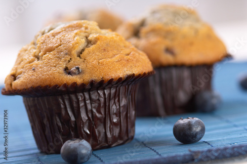 Photo: blueberry Muffin on a blue place mat blueberry Muffin on a blue place mat