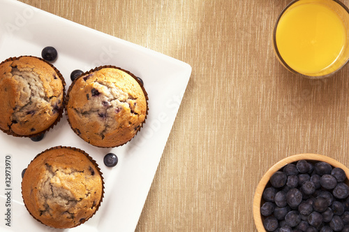 Photo: muffin on a sqare plate, orange juice and blueberry muffin on a sqare plate, orange juice and blueberry