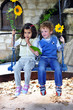 boy and girl sitting on a colorful bench